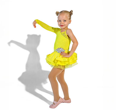 A young dancer in a bright yellow costume posing confidently with one arm raised against a white background.